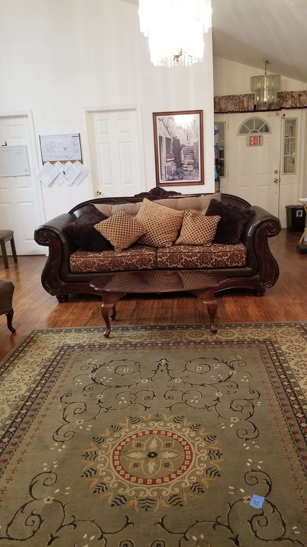 A cozy living room with a classic sofa, decorative pillows, and an ornate coffee table.
