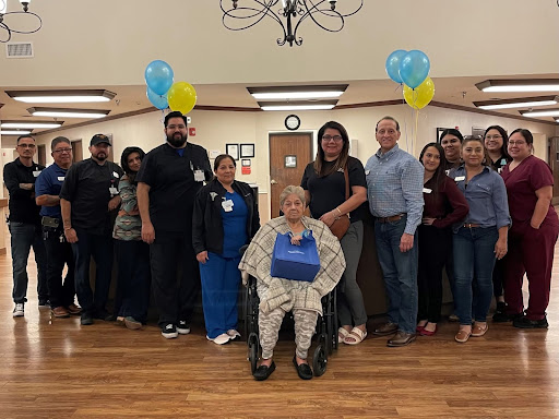 A joyful celebration with staff and residents at a senior care facility.