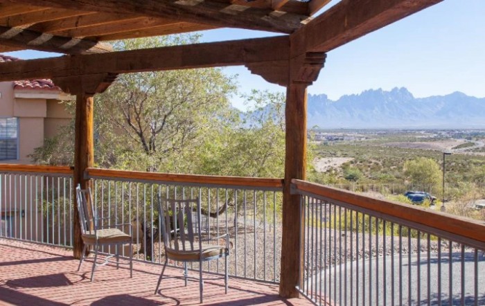 A serene patio overlooking a beautiful mountain landscape.
