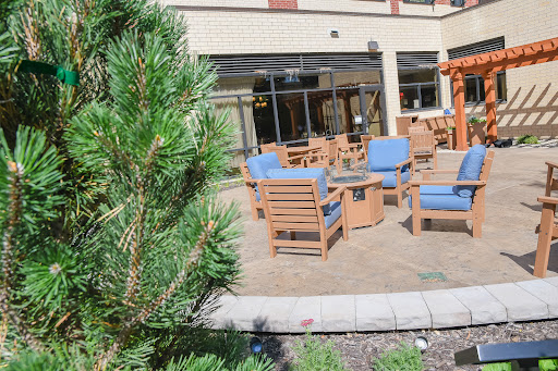 A cozy outdoor seating area surrounded by greenery, perfect for relaxation.
