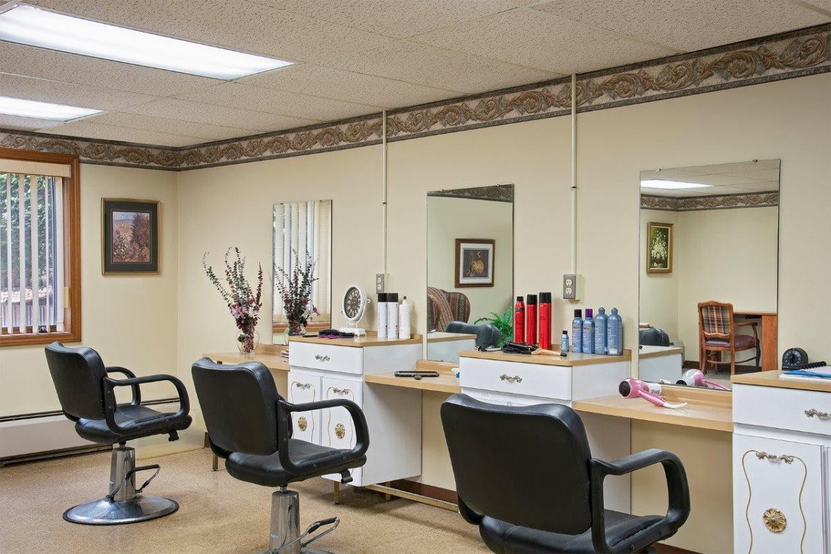 A well-organized hair salon with styling stations and mirrors.