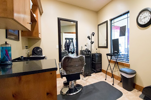 A cozy hair salon space featuring a stylish barber chair and essential tools for hair styling.