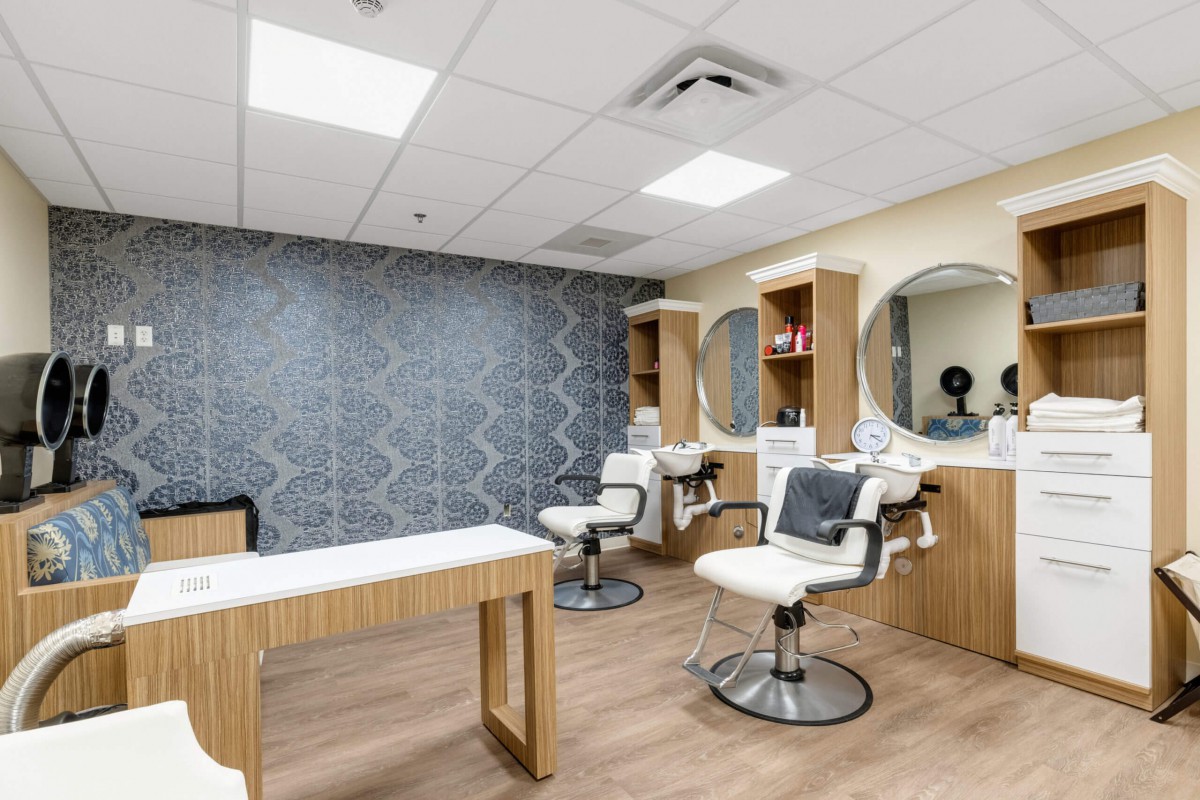 A modern beauty salon interior with styling chairs and mirrors.
