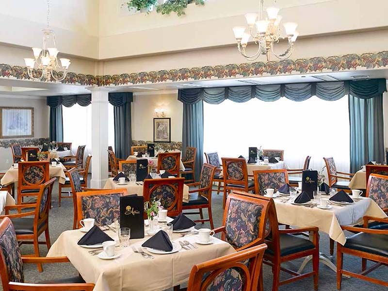 An elegantly decorated dining room with tables set for guests.