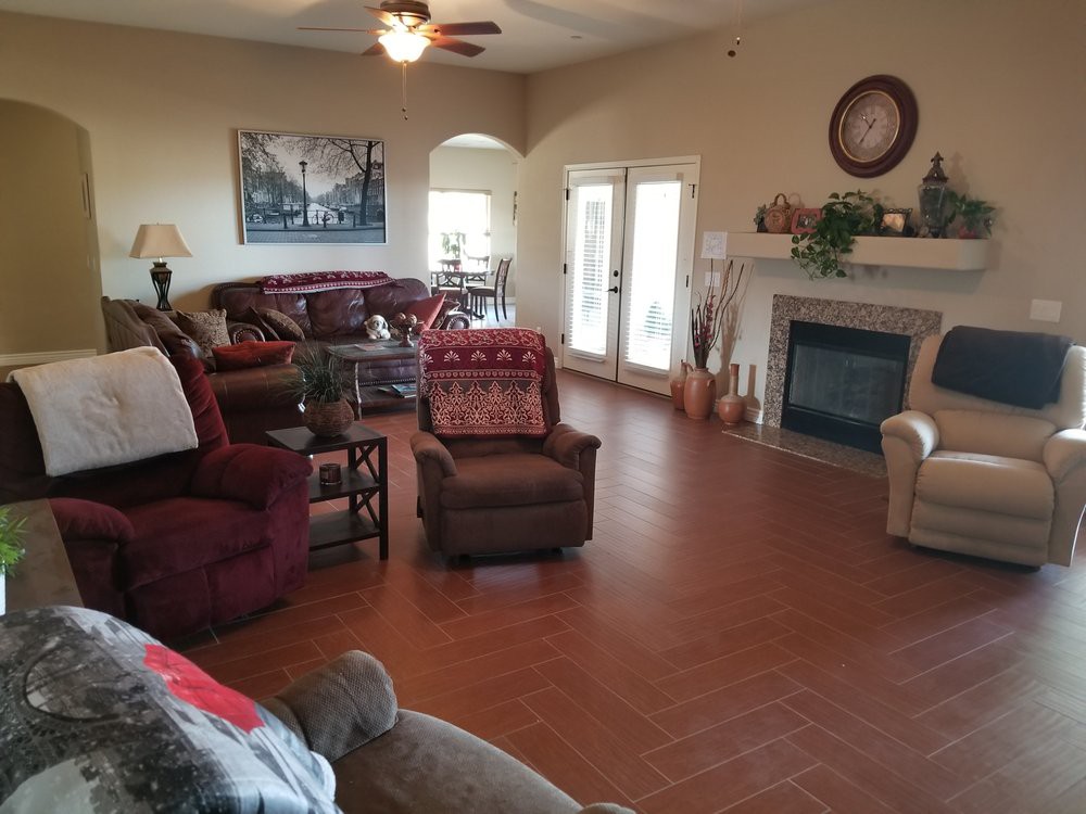 A cozy living room with comfortable seating, a fireplace, and tasteful decor.