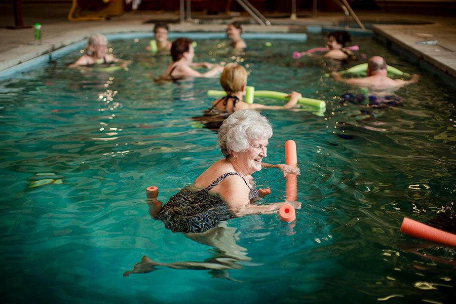A group of seniors enjoying a water aerobics class in the pool.