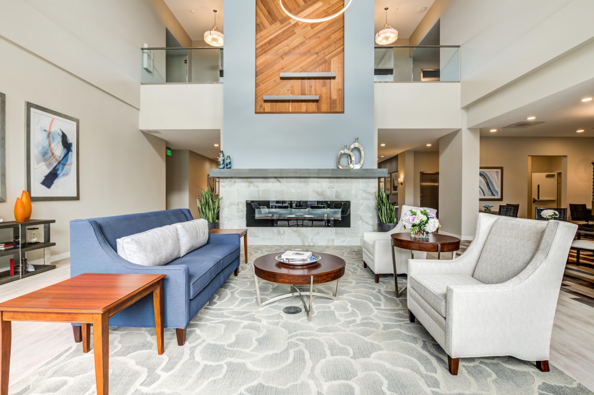 A modern living room with a stylish fireplace, comfortable seating, and elegant decor.