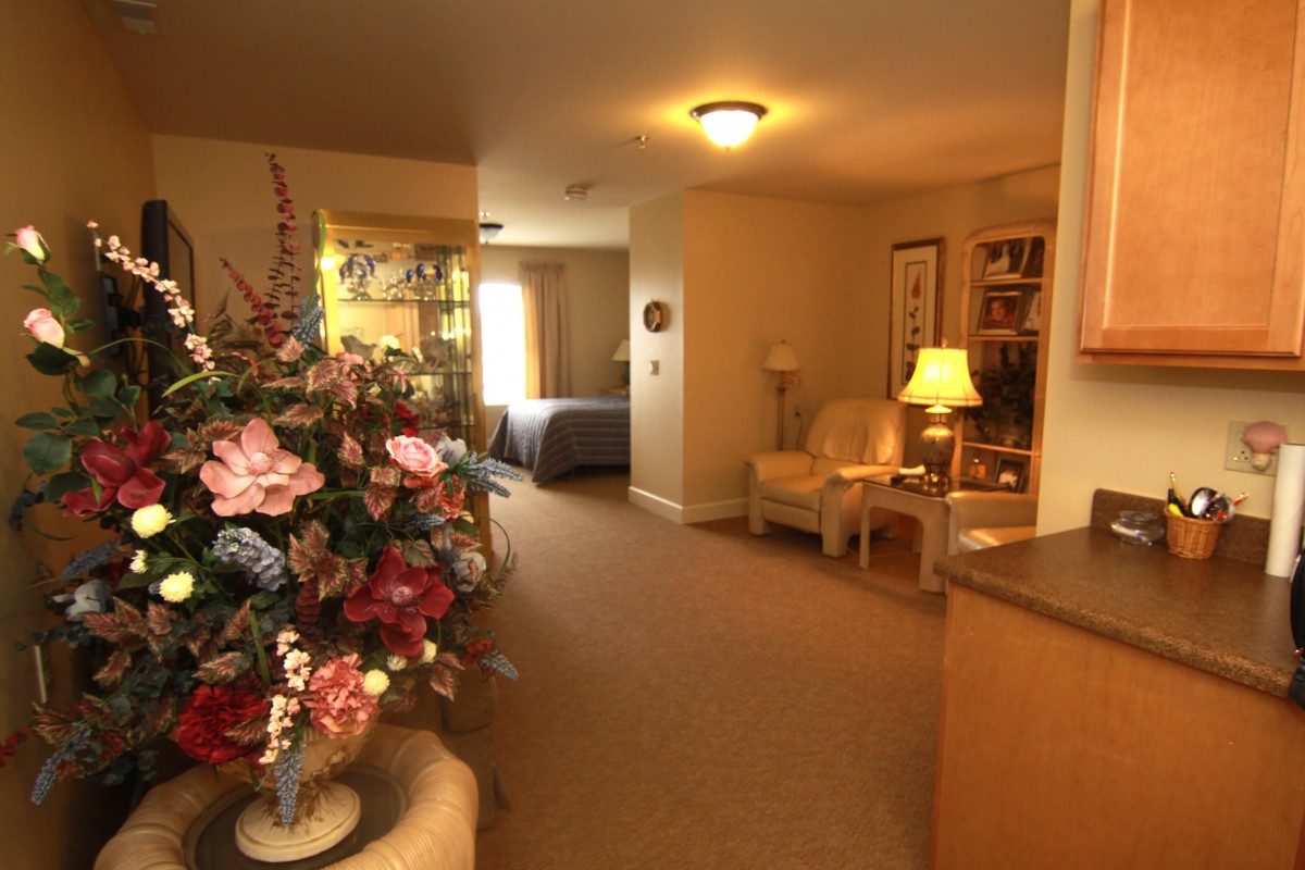 A cozy living room with floral decorations and soft lighting.