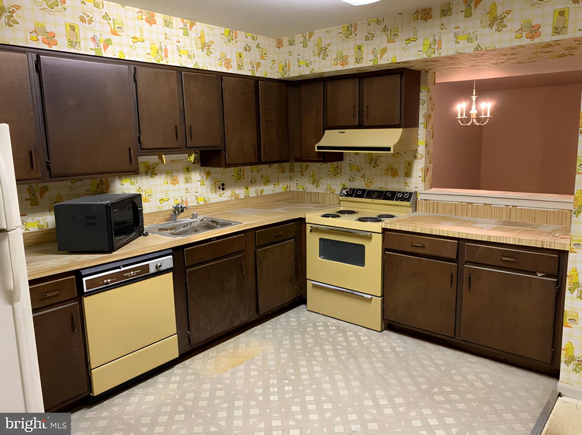 Retro-style kitchen with yellow appliances and brown cabinets.