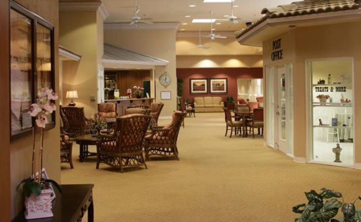 A spacious furniture showroom displaying tables and chairs under soft lighting.