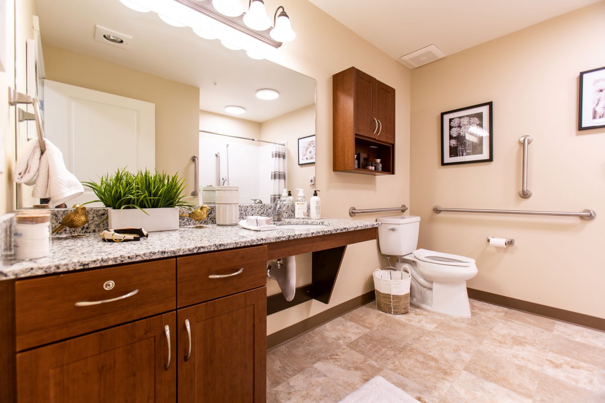 A modern bathroom with sleek cabinetry and warm lighting.