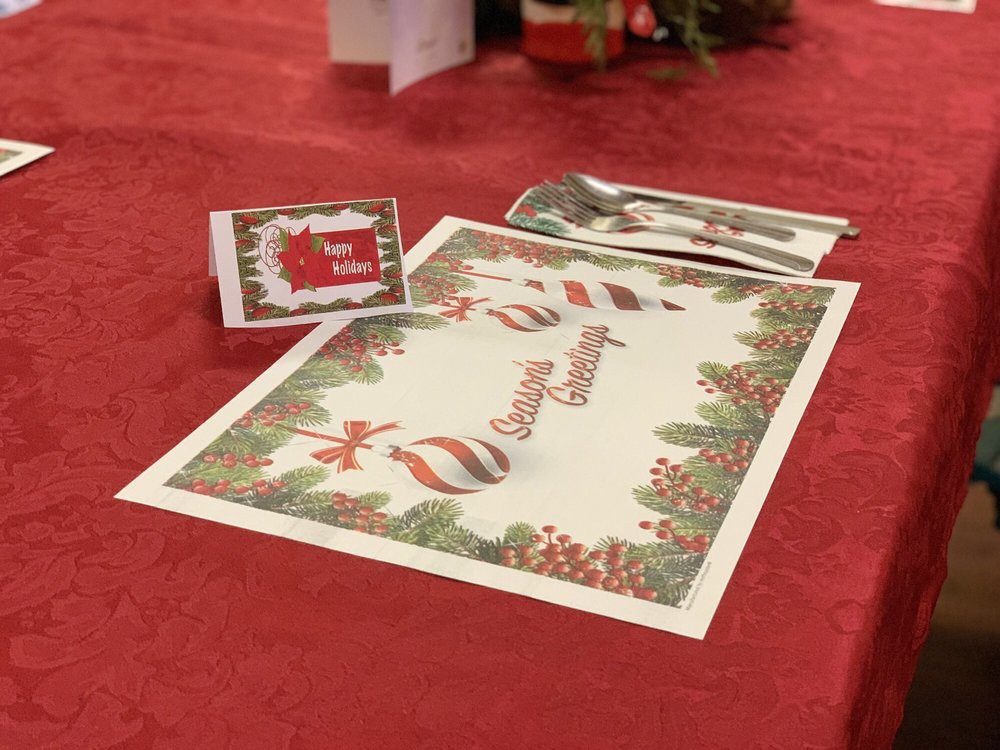 Festively decorated table with a Christmas-themed place card and menu.