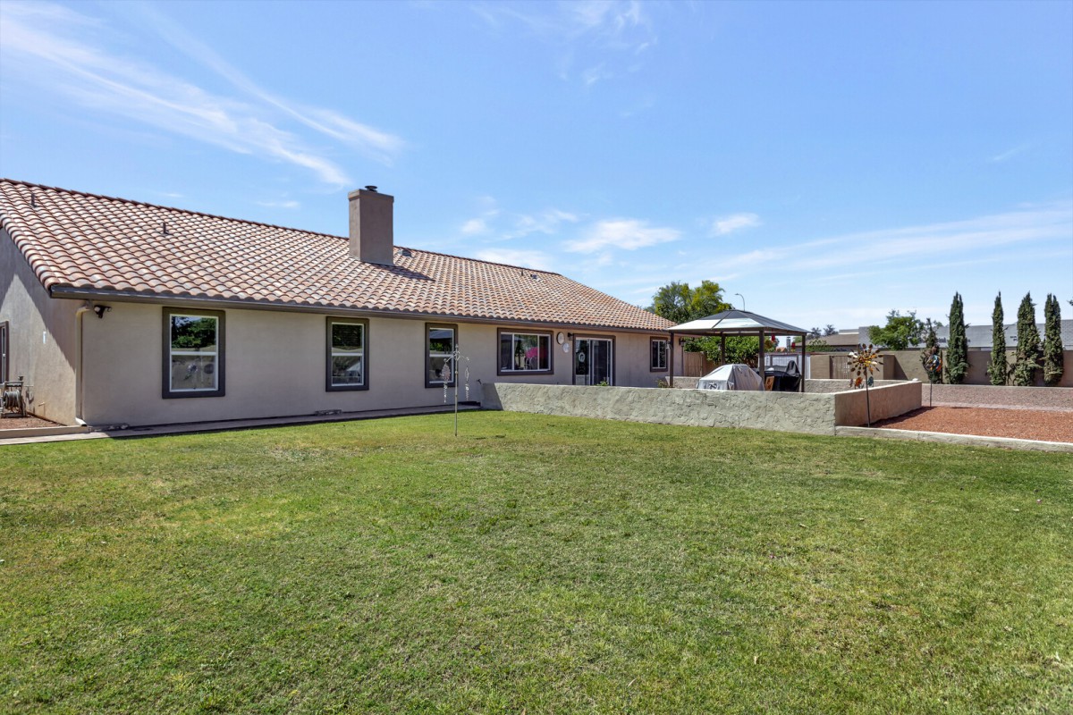 A suburban house with a spacious backyard and patio.