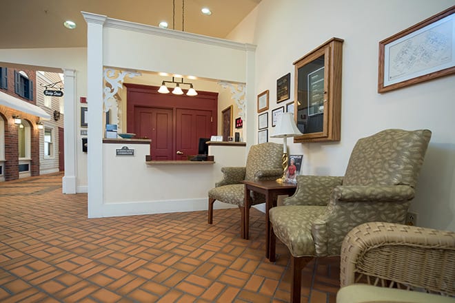 A cozy reception area with comfortable seating and warm lighting.