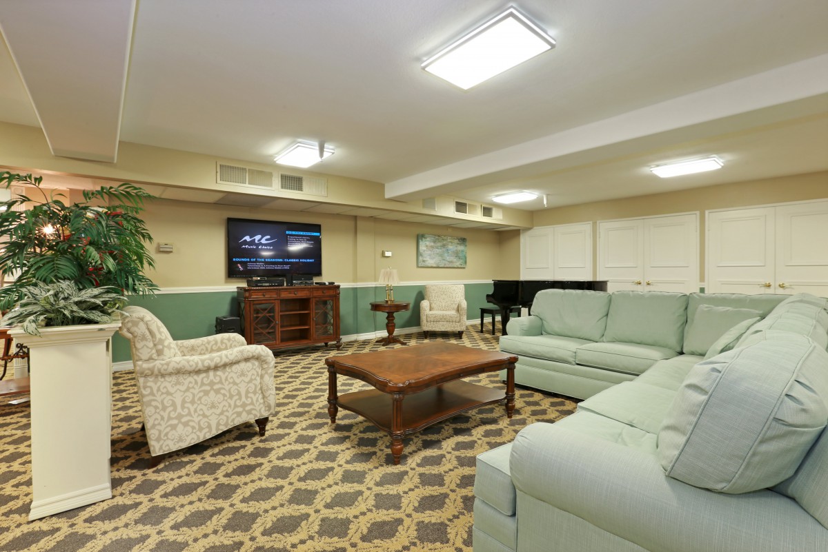 A cozy living room with a sofa set, coffee table, and television.