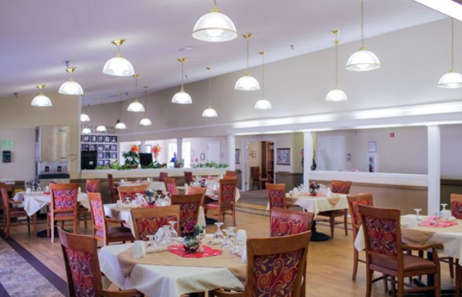 An elegant dining area with neatly arranged tables and chairs.