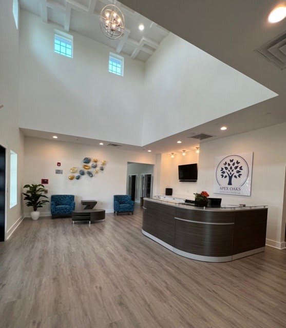 A modern office reception area with a sleek desk, comfortable seating, and stylish decor.