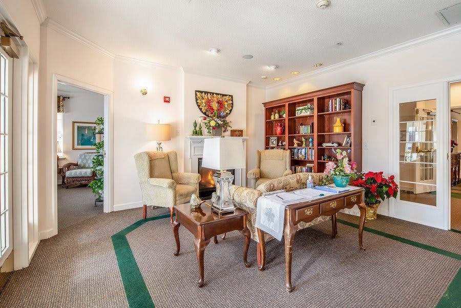 A cozy living room with elegant furniture and a well-organized bookshelf.
