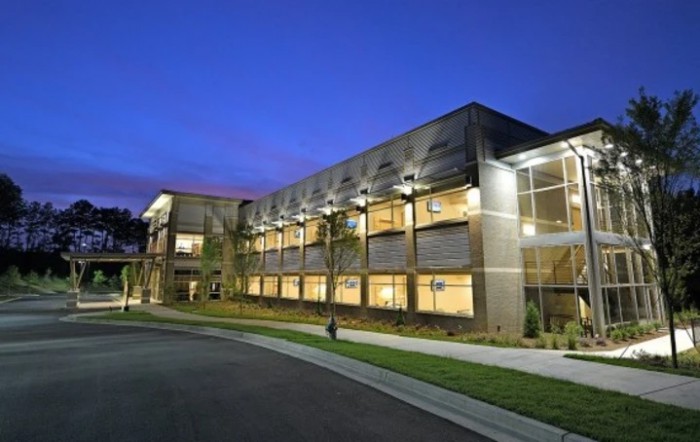 A modern building illuminated at night.