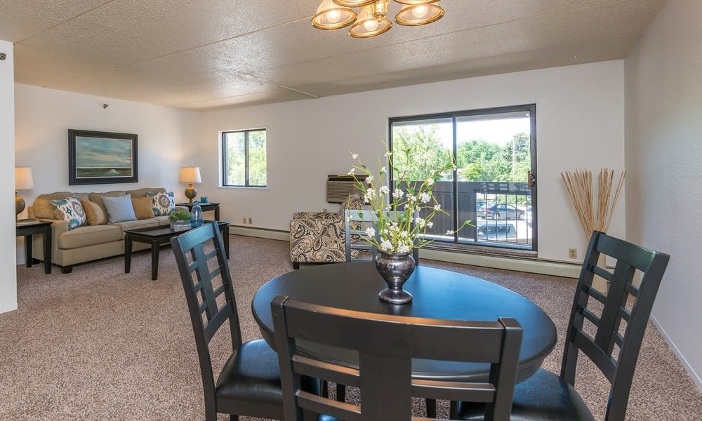 A spacious living and dining area with modern furniture and plenty of natural light.