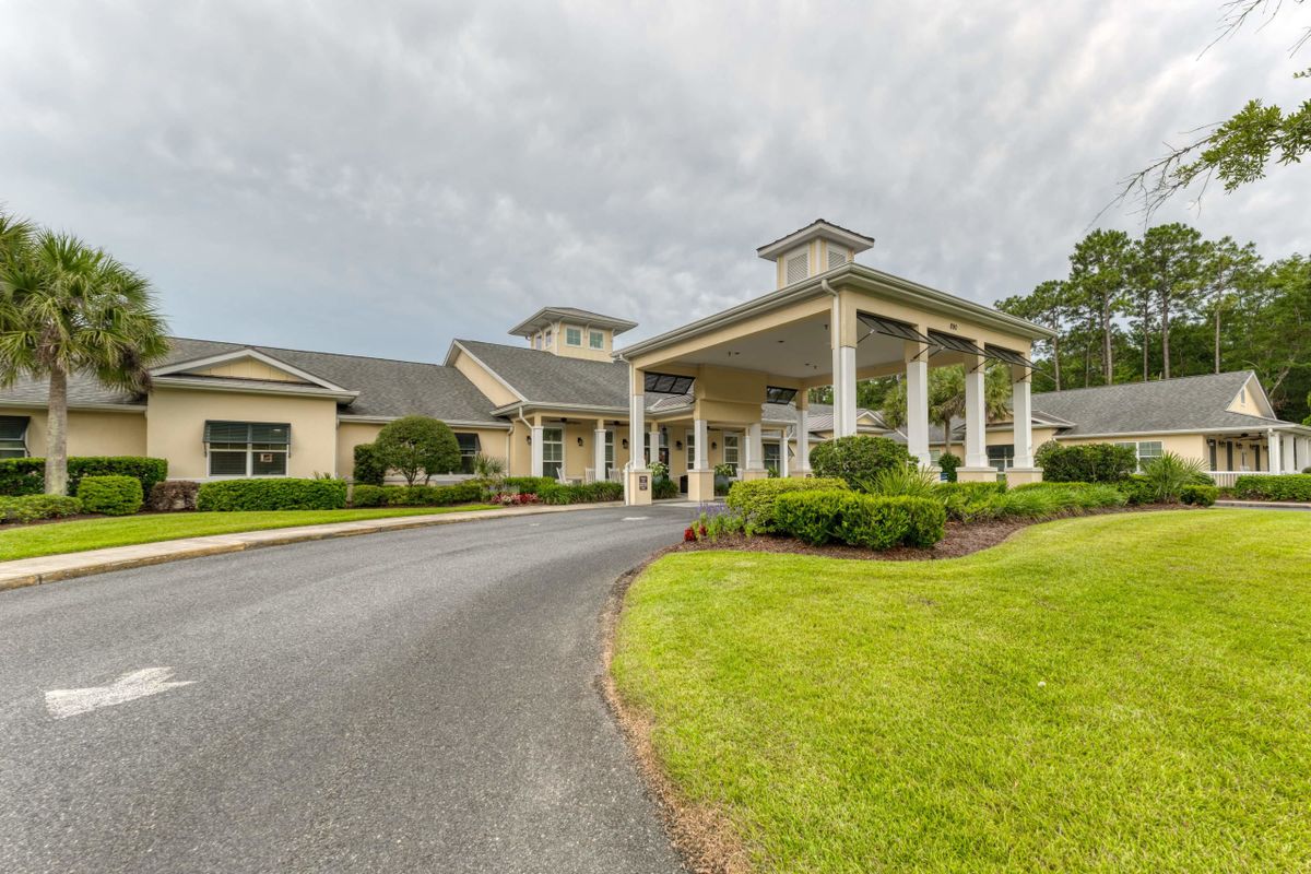 A large building with an elegant entrance and well-maintained landscaping.