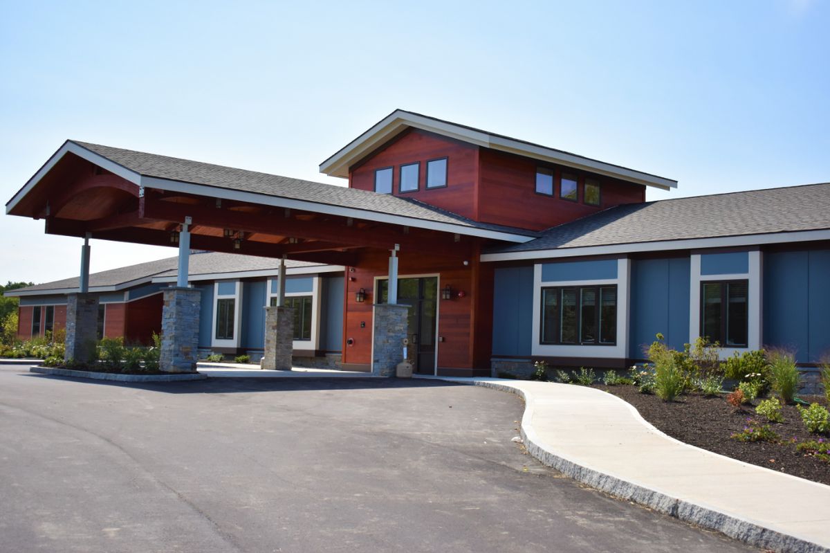 A modern building with a prominent entrance and sleek architectural design.