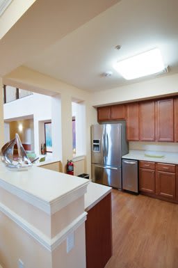 A modern kitchen with stainless steel appliances and wooden cabinets.