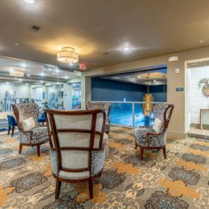 A cozy hotel lobby with elegant seating areas and a pool view.