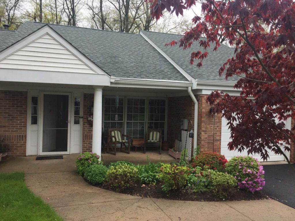 A cozy house with a well-maintained garden and inviting front porch.