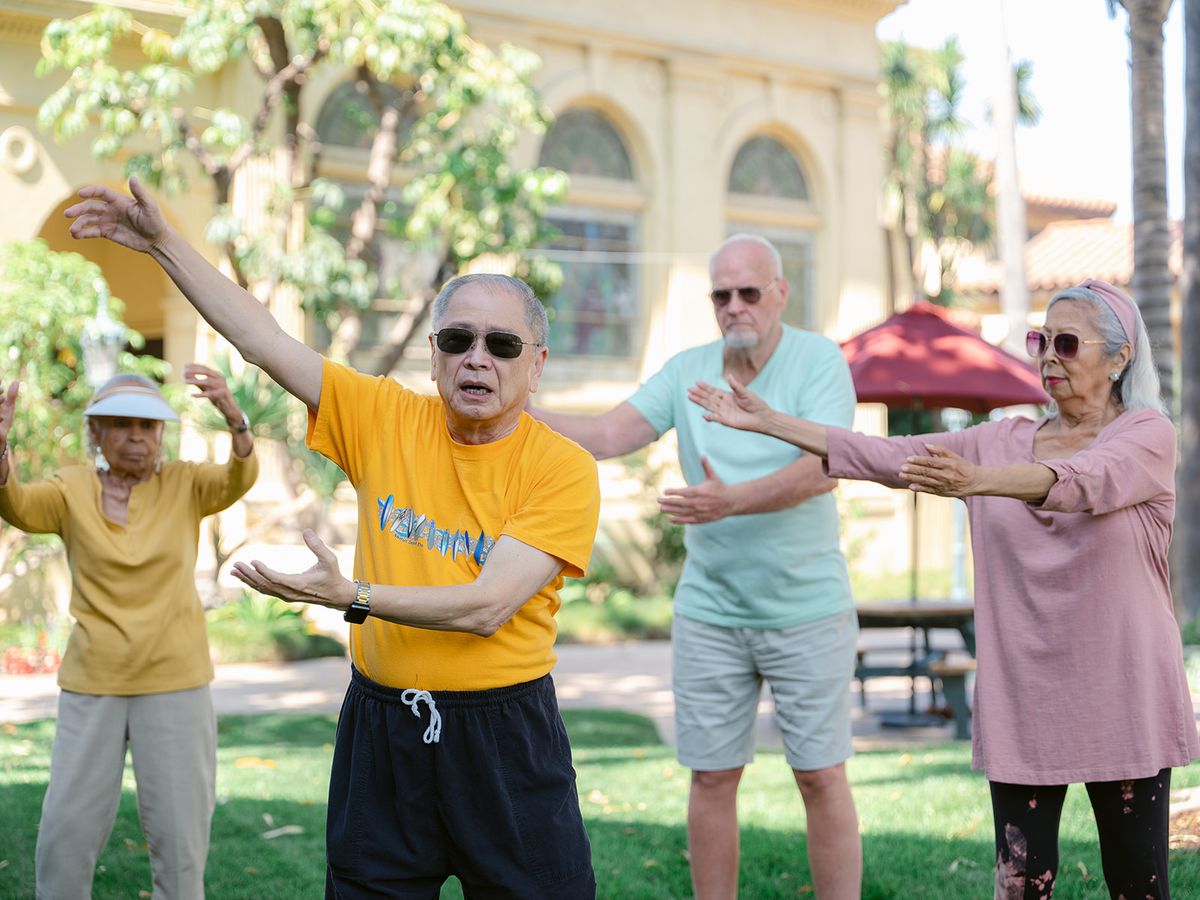 A group of seniors practicing tai chi in the park.