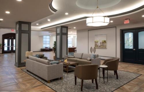 A modern and spacious living room with elegant furniture and lighting.