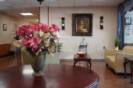 A cozy and inviting waiting area featuring a floral arrangement and artistic decor.