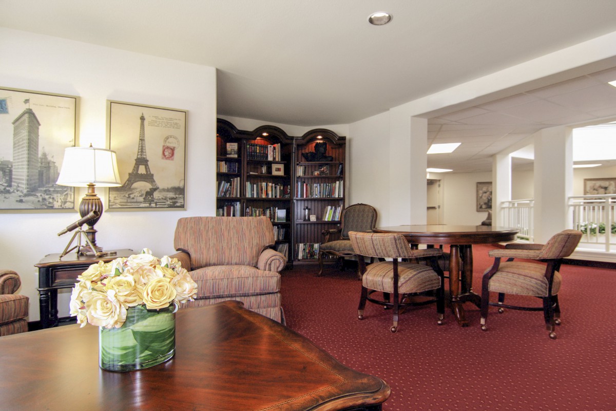A cozy living room with comfortable seating and bookshelves.