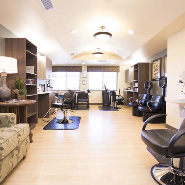 A modern and spacious salon interior with multiple styling stations.