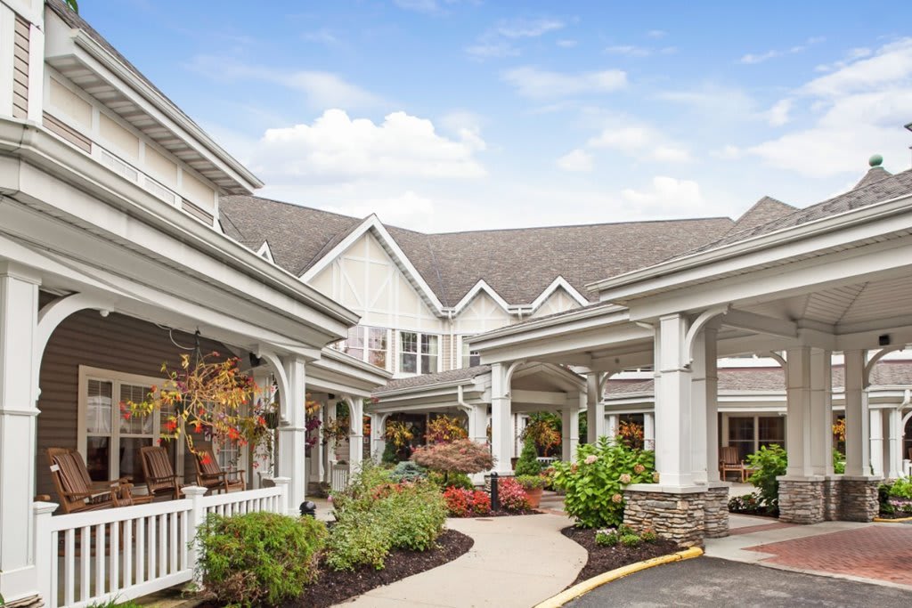 An inviting building entrance with well-maintained landscaping and a clear pathway.