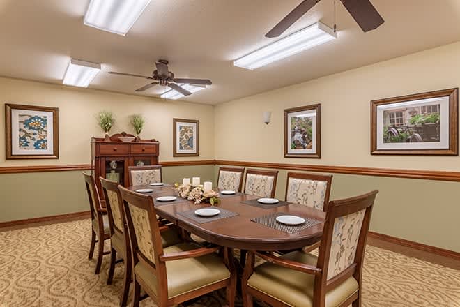 A well-decorated dining room with a large table and chairs.