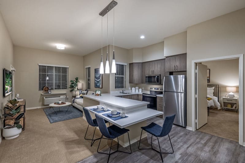 A modern open-concept kitchen and dining area with sleek appliances and contemporary furniture.