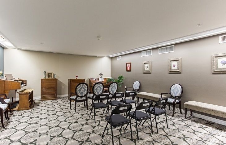 A small, well-decorated meeting room with neatly arranged chairs and patterned floor tiles.