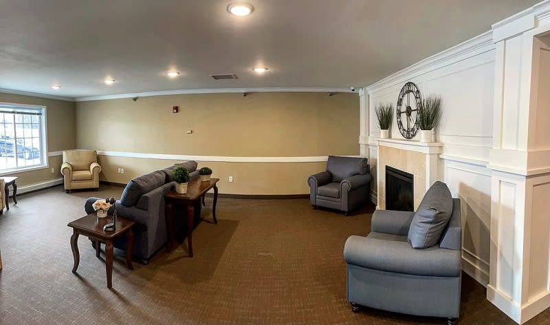 A cozy living room with comfortable seating and a fireplace.