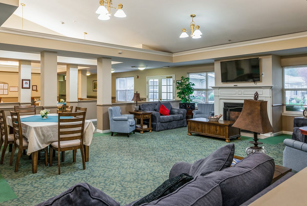 A spacious living room with comfortable seating, a television, and a dining area.