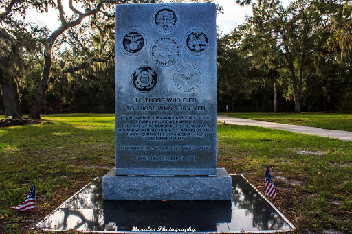 A memorial stone dedicated to honoring individuals, featuring engraved illustrations and text.