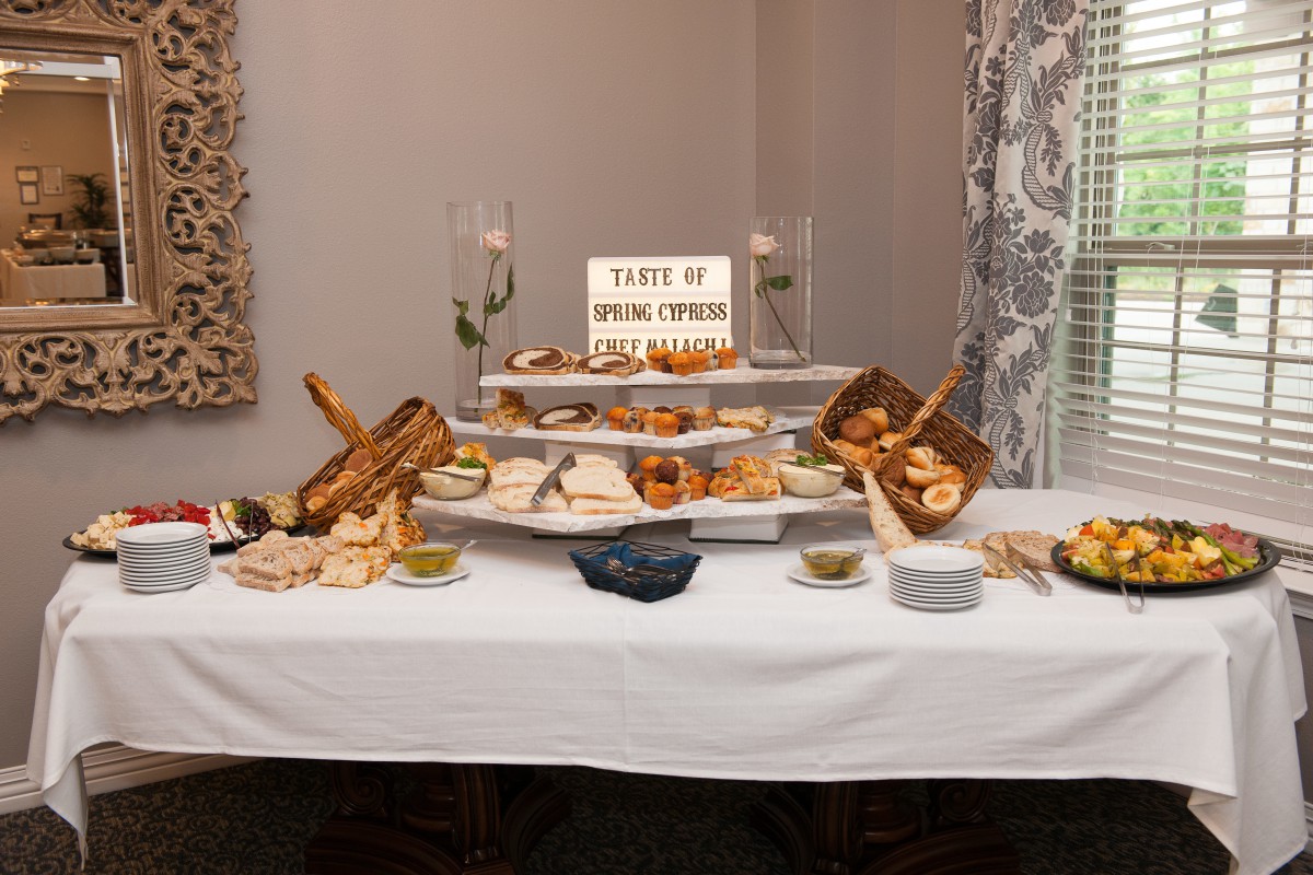 A beautifully arranged buffet table featuring an assortment of breads, pastries, and cheeses.