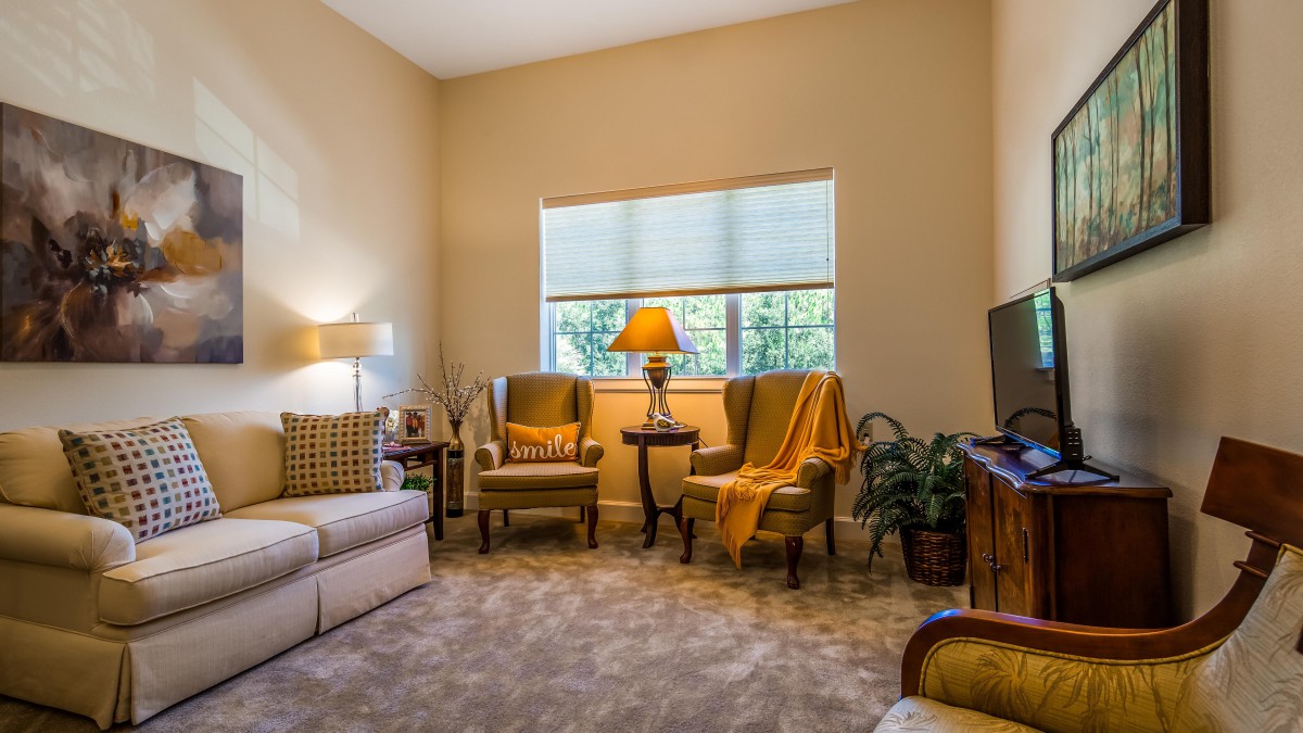 A cozy living room with comfortable seating and warm lighting.