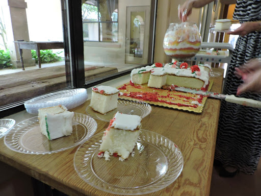 A delightful display of sliced cake with strawberries and cream, served on a wooden table.