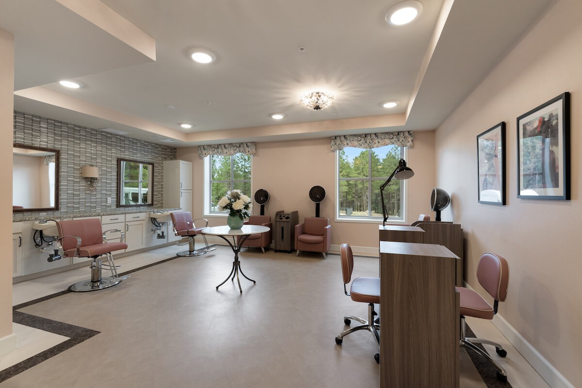 A well-lit salon interior with hair styling stations and comfortable chairs.