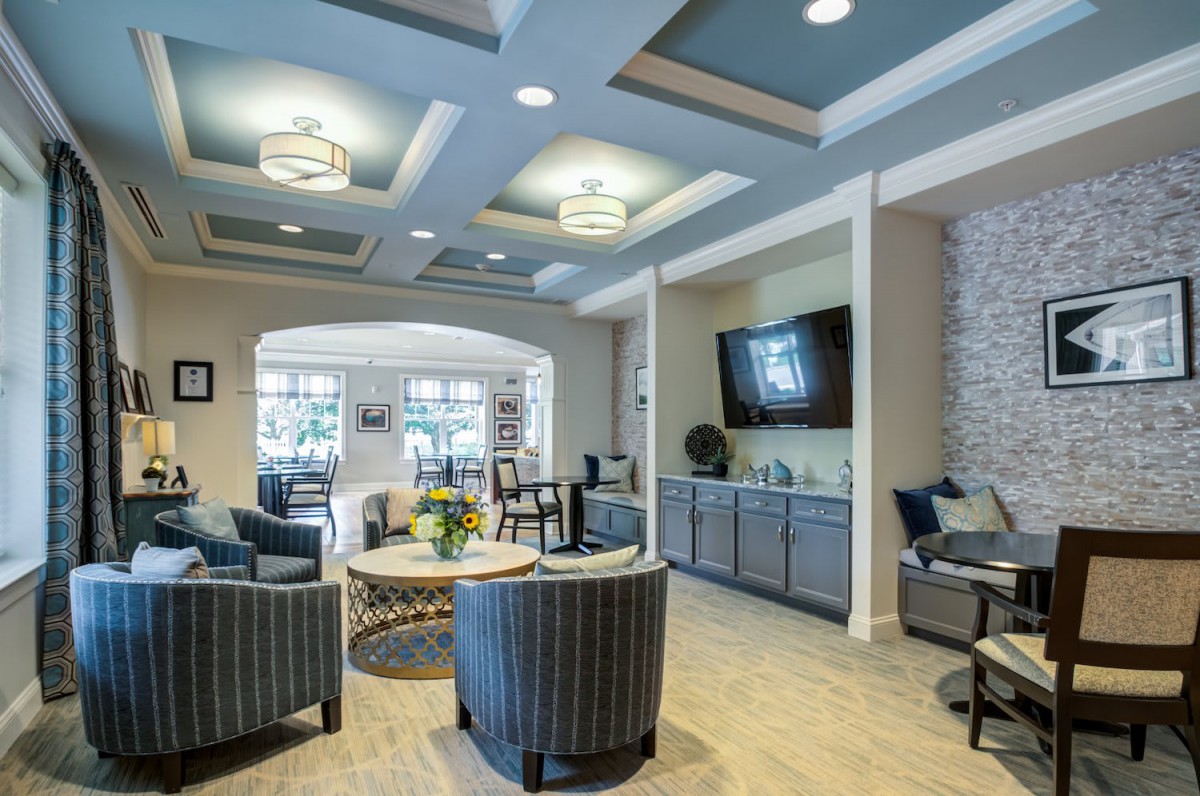 A modern living room with comfortable seating, a wall-mounted television, and stylish decor.
