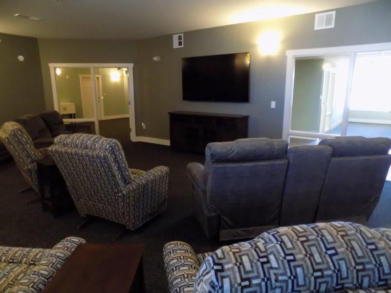 A cozy living room setup with comfortable chairs and a large TV.