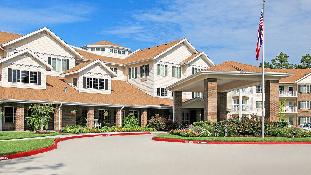 A modern residential building with landscaped surroundings.
