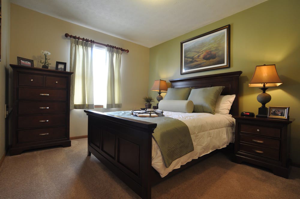 A cozy bedroom with elegant furnishings and warm lighting.