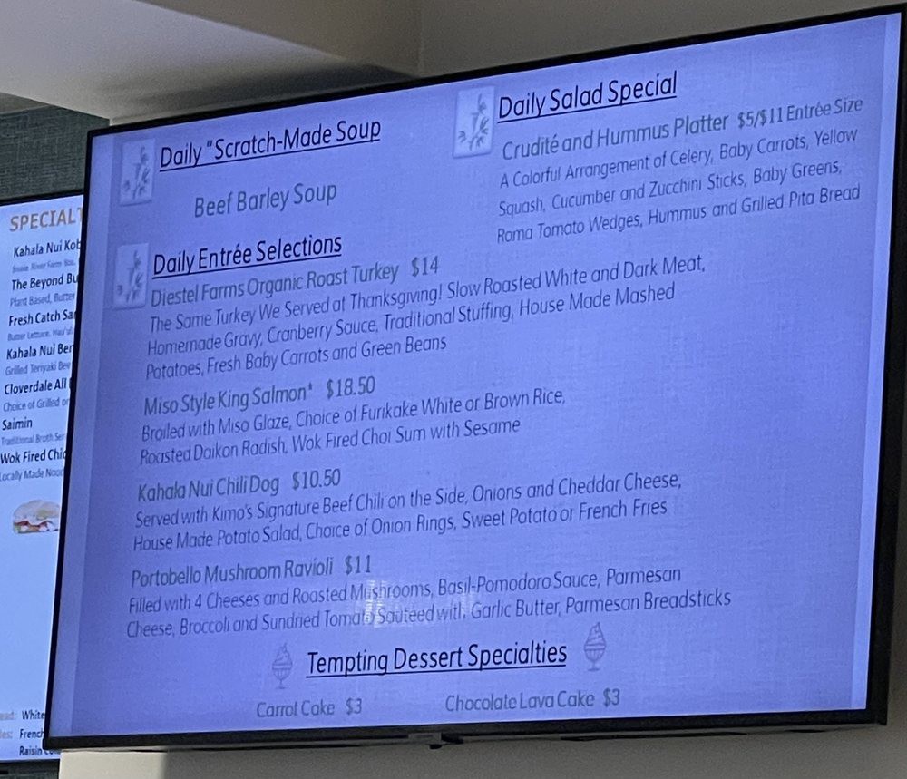 A television displaying a menu with various food options.